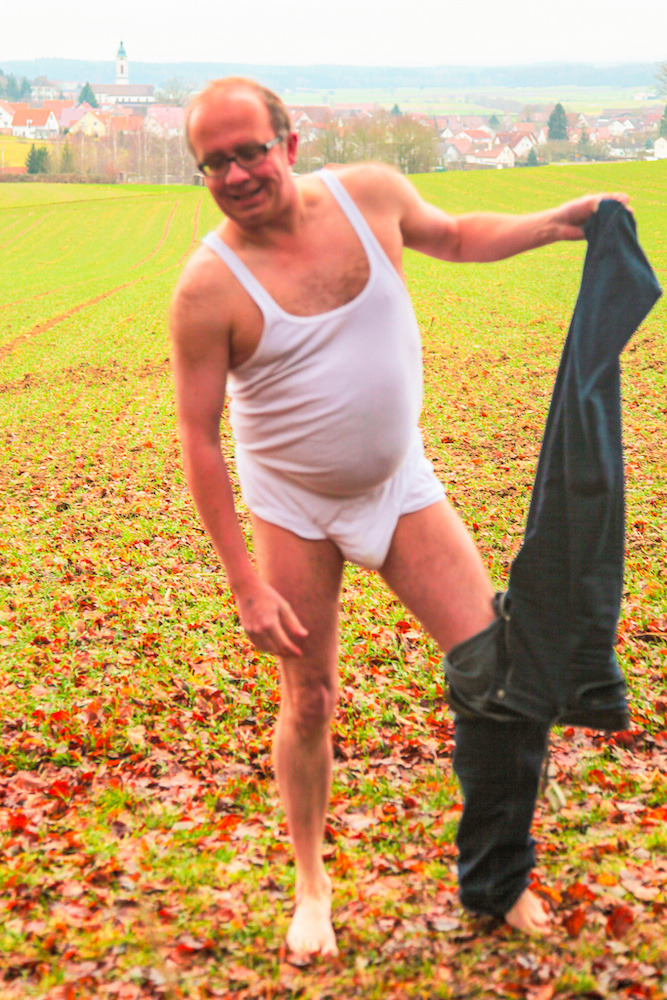Outdoors in the fields in front of a village I am in my white underwear, which can be easily seen from far away. Now I complete the undressing of my black jeans. My naked skin has become red from the cold January temperatures.